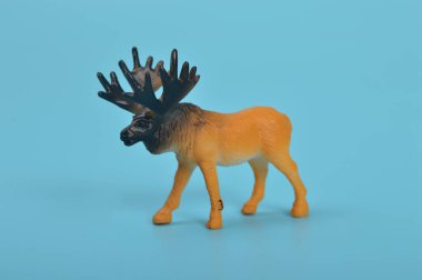 Toy Elk isolated on a blue background