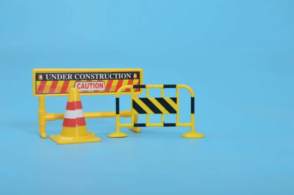 Traffic road barrier: A warning barrier for road closure and website under construction page. Includes warning and stop signs, roadwork, traffic barricades, cones, and safety barricades.