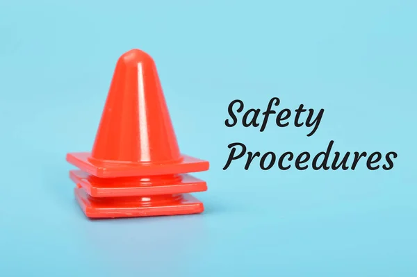 Red safety cones with text SAFETY PROCEDURES.