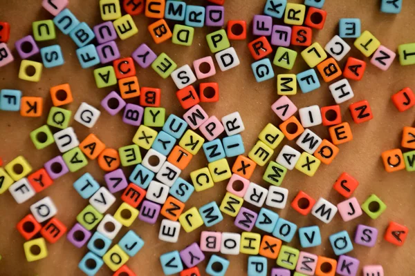 Colorful Alphabet Beads Wooden Background — Stock Photo, Image