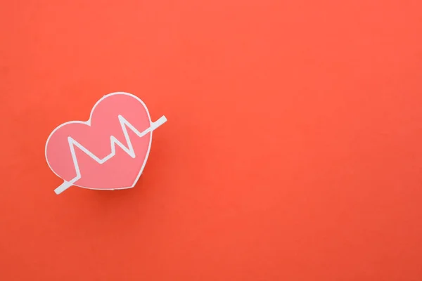 Heart beat isolated on a red background. symbolize routine medical check-ups, diagnostics, and the importance of heart health examinations