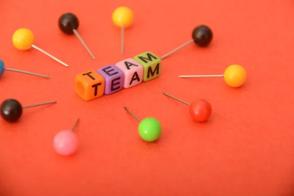 stock image Alphabet beads with text TEAM. In a business context, a team refers to a group of individuals working collaboratively and cooperatively toward a common goal or objective.