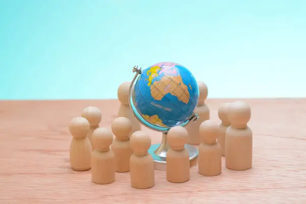 The wooden figures encircling together, highlighted the synergy among teammates, emphasizing the strategic vision needed to navigate the complexities of a global business landscape