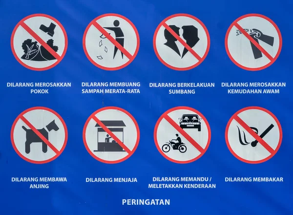 A poster in a summer park features numerous prohibition signs, including instructions not to litter, smoke, drive cars or motorbikes, light fires, bring dogs into the park, step on the grass, or engage in grocery shopping or couples activities