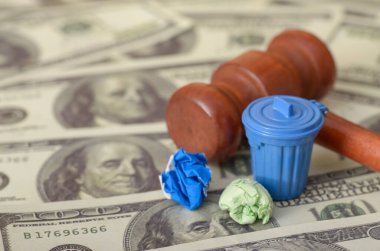 The sight of a judge's gavel with money and a trash bin, accompanied by a fine, symbolizes the consequences of economic wastefulness and legal enforcement. clipart