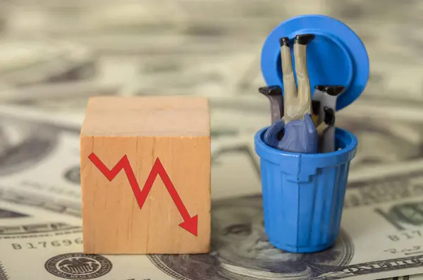 stock image The image of businessmen slumped in a trash bin serves as a powerful metaphor for the collapse of unsustainable economic systems.