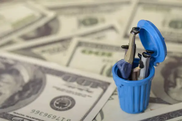 stock image Businessmen slumped in a trash bin underscores the harsh realities of economic recession and instability impacting all levels of the economy.