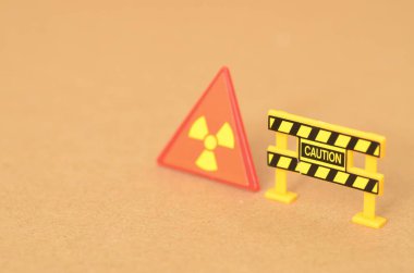 The caution sign and barricade clearly indicate a hazardous area due to the presence of radiation. clipart