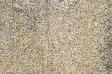 Yıpranmış beton bir yüzey. Kumun kaba, kumlu dokusu ve çok yönlü inşaat temalı arka planlar için ince bir kütle..