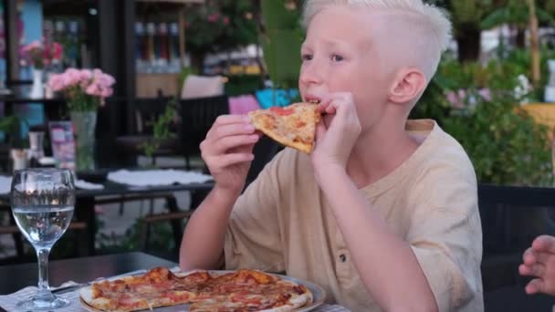 レストランで子供のピザを食べて幸せな男の子 子供用のメニュー 若い人のための動物の形のイタリアのピザ 高品質4K映像 — ストック動画