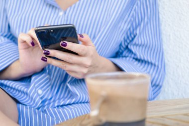 Woman using mobile phone typing text, checking social media or shopping online. . High quality photo