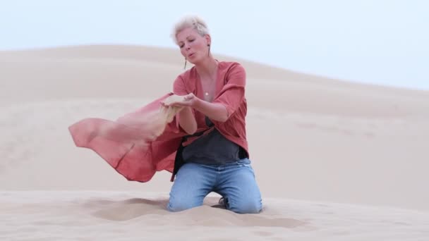Ξανθιά Γυναίκα Κομψά Ρούχα Απολαμβάνοντας Άμμο Στους Αμμόλοφους Της Ερήμου — Αρχείο Βίντεο