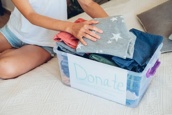 stock image Woman sorts wardrobe indoors at home. Charity donation concept. High quality photo