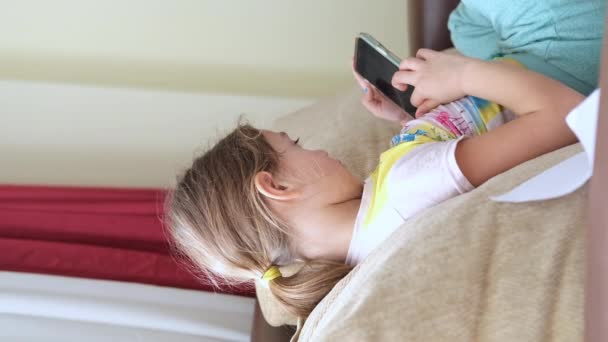 Cute Little Girl Using Technology Device Sitting Sofa Girl Playing — стоковое видео
