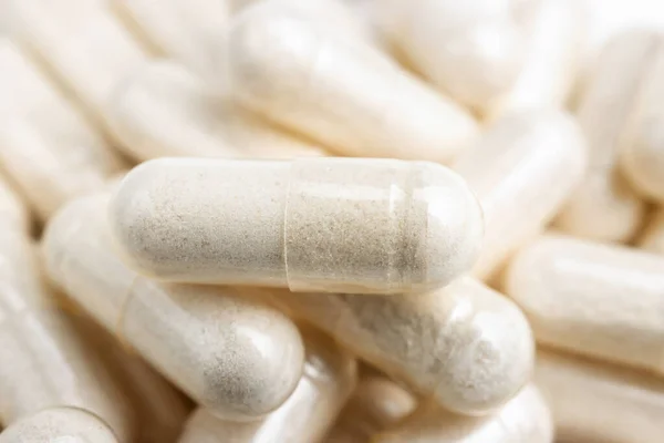 White medicine capsules, vitamin pills or drugs, medication treatment, health care concept.