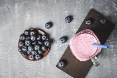 Blueberry smoothie drink in a glass jar, top view, healthy eating concept.