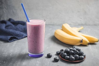 Blueberry and banana smoothie drink in a glass, healthy eating concept.