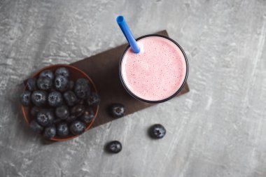 Blueberry smoothie drink in a glass, top view, healthy eating concept.
