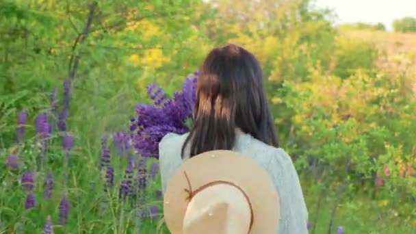 Visão Traseira Jovem Mulher Sorridente Vestido Chapéu Com Flores Lupin — Vídeo de Stock
