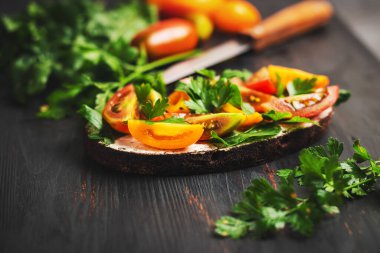 Ekmek, peynir, roka, maydanoz ve domatesli sağlıklı vejetaryen sandviçi..