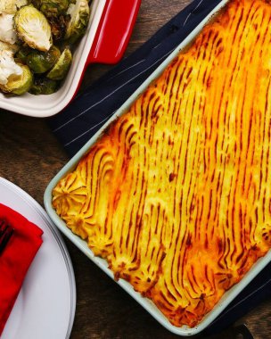 Köy mutfağında kremalı patates püresiyle kaplı lezzetli çoban pastası. Sıcak yemekler, tarif blogları ya da klasik yemek içeriği için mükemmel ev yapımı konforlu yemekler..