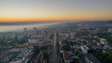 Chisinau 'nun güneş doğarken Moldova' daki hava aracı görüntüsü. Şehir merkezinin sisle kaplı görüntüsü, birden fazla bina, hareket eden arabalar