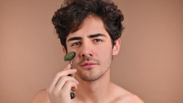 Young Caucasian Man Stubble Beard Doing Facial Massage Using Roller — Stock Video