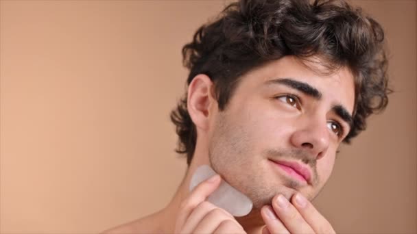 Young Caucasian Man Stubble Beard Doing Facial Massage Using Gua — Stock Video
