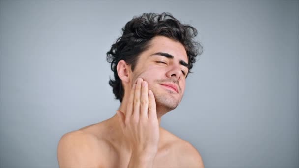 Young Caucasian Man Stubble Beard Moisturizing Face Skin Cosmetic Oil — Stock Video