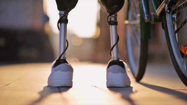 Slow Motion View Man Prosthetic Legs Walking Bicycle Street Sunset — Stock Video