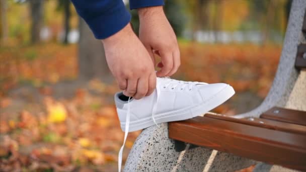 Slow Motion View Man Prosthetic Legs White Sneakers Tying Shoelaces — Stock Video