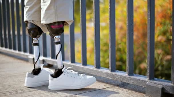 Slow Motion View Man Prosthetic Legs White Sneakers Standing Fence — Stock Video