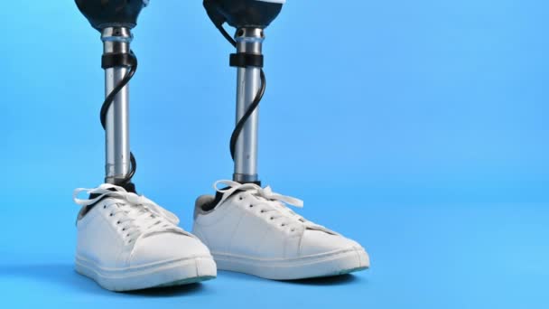 View Man Prosthetic Legs White Sneakers Standing Blue Background — Stock Video