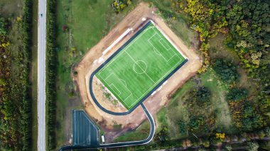 Vertical drone view of a football stadium in the nature