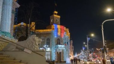 CHISINAU, MOLDOVA - DECEMBER, 2022: Timelapse view of city hall in centre with Christmas decorations, walking people, bare trees