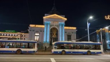 CHISINAU, MOLDOVA - DECEMBER, 2022: Timelapse view of organ hall in centre with Christmas decorations, walking people, moving cars, bare trees