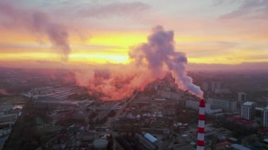 Aerial drone view of thermal power plant in Chisinau at sunrise, Moldova. View of pipes with felling steam, cityscape