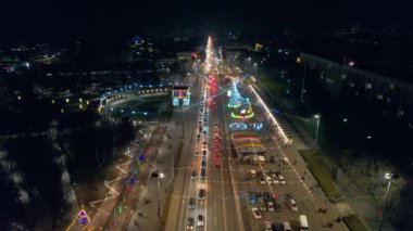 Aerial drone view of Chisinau at night, Moldova. View of city centre with Christmas decorations, buildings, roads, illumination