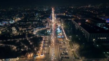Aerial drone timelapse view of Chisinau at night, Moldova. View of central park with Christmas decorations, roads, illumination