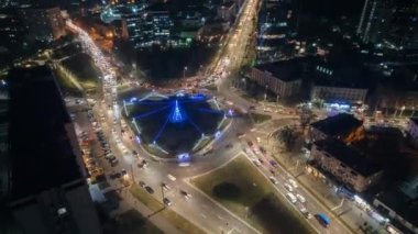 Aerial drone timelapse view of Chisinau at night, Moldova. View of city centre with Christmas decorations, buildings, roads, illumination