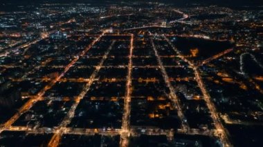 Aerial drone timelapse view of Chisinau at night, Moldova. View of city centre with multiple buildings, roads, illumination