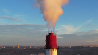 Aerial drone view of thermal power plant in Chisinau at sunrise, Moldova. View of pipe with felling steam
