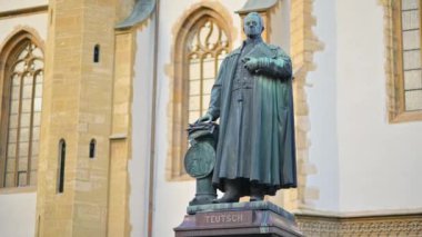 Monument of Bishop Georg Daniel Teutsch with Sibiu Lutheran Cathedral on the background in Romania