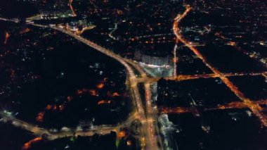 Aerial drone view of Chisinau at sunset, Moldova. View of the city with multiple buildings, roads with traffic, illumination