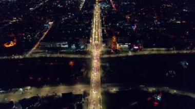 Aerial drone view of Chisinau at sunset, Moldova. View of city centre with multiple buildings, roads with traffic, illumination