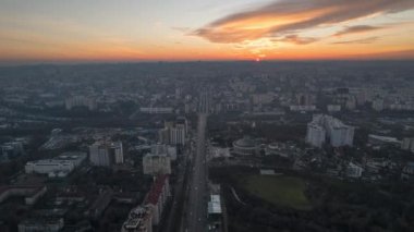 Aerial drone timelapse view of Chisinau at sunset, Moldova. View of the city with multiple buildings, roads with traffic
