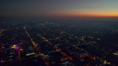 Aerial drone view of Chisinau at sunset, Moldova. View of city centre with multiple buildings, roads, illumination