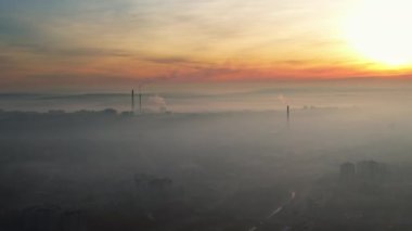 Aerial drone view of Chisinau at sunrise, Moldova. View of the city with fog in the air, pipes with felling steam, cityscape