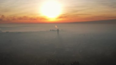 Aerial drone view of Chisinau at sunrise, Moldova. View of the city with fog in the air, pipes with felling steam, cityscape