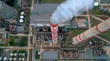 Aerial drone view of thermal power plant in Chisinau at cloudy weather, Moldova. View of pipes with felling steam, cityscape